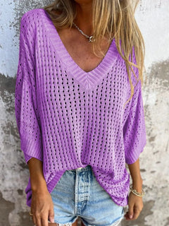 Person wearing a purple crochet bikini cover up that could double as a summer sweater. three quarter sleeves with V neck