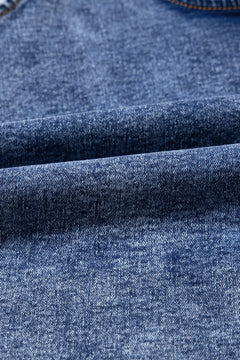 Close-up of blue denim fabric with a subtle pattern