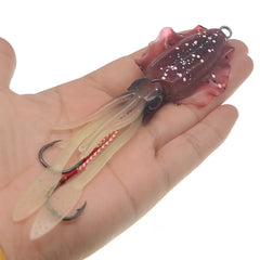 Fishing lure held in a hand against a white background