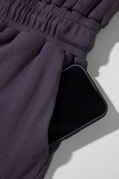 Phone in a pocket of dark pants on a light background