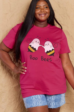 Person wearing a pink t-shirt with 'Boo Bees' design against a beige background