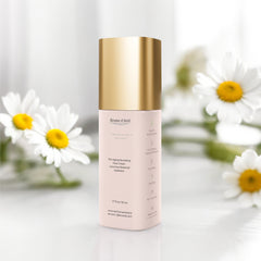 50ml bottle of Brume D'Avril Pro-aging nourishing face cream on a white background with daisiey on the table behind it