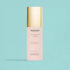 50 ml bottle of Brume d'Avril milky oil foaming cleanser on a blue background