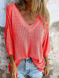 Person wearing a red crochet bikini cover up that could double as a summer sweater. three quarter sleeves with V neck