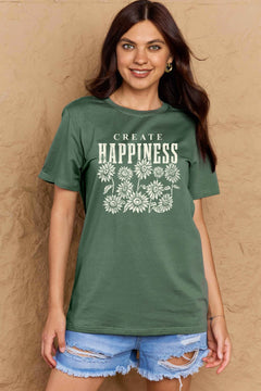 Green Tshirt with round neck and short sleeves, the caption in capital letters says CREATE HAPPINESS, with create being in small letters centered over Happiness. underneath the letters, in white as well, ten flowers arranged in three rows.