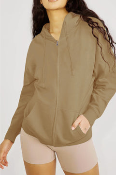 Person wearing a brown zip-up hoodie and beige shorts on a white background