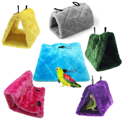 Set of colorful bird hammocks in various colors with a parrot toy on a white background.