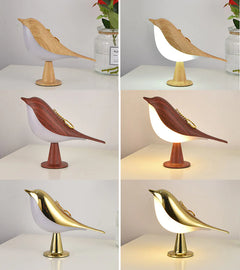Bird-shaped lamps in various colors on a white surface with a neutral background.