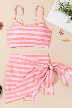 Pink and orange checkered bikini set that includes croptop, highwaisted bottoms, and short sarong skirt