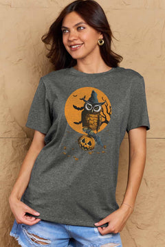 Woman wearing a dark gray t-shirt with a Halloween-themed design featuring an owl and pumpkin.