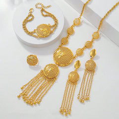 Gold jewelry set with necklace, bracelet, and earrings on a white background
