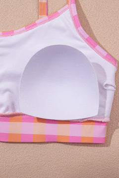 White bikini top with pink and orange plaid pattern shown inside out to show the removable padding