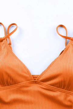 Orange ribbed bikini top on a white background