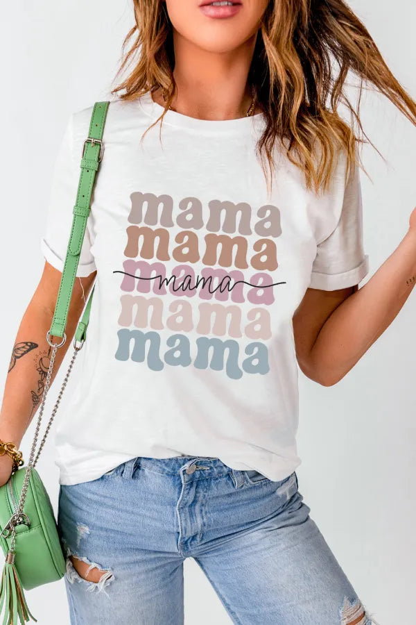 Person wearing a white t-shirt with 'mama' text in various colors, holding a green bag.