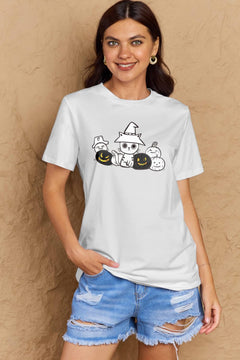 Woman wearing a white t-shirt with Halloween-themed design against a beige wall
