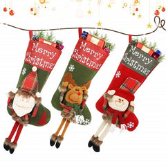 Three Christmas stockings with festive designs and 'Merry Christmas' text, hanging on a branch.