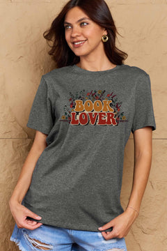 A grey t-shirt with 'Book Lover' printed in front of s mass of small flowers and stems
