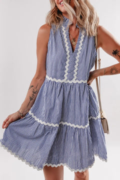 Blue and white vertical striped dress with ricrac ribbbon  trim on and V neck with frill collar, no sleeves
