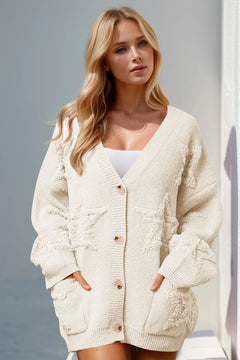 Full Size Button Up Star Pattern Cardigan with deep V neck and 4 oversized tan buttons wide hem around the neck, sleeves, and sweater edges. Solid white color with  fuzzy stars on pockets, sleeves and front of shirt in same color
