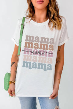 Woman wearing a white t-shirt with 'mama' text in various colors, holding a green purse.