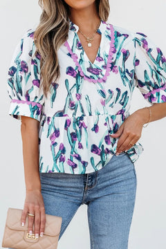 White top with purple flowers on bluish stems, trimmed with lilac scalloped piping around neck and sleeves.