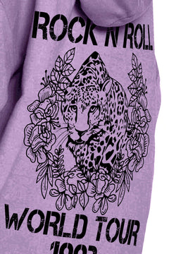 close up of design on Purple hoodie with Rock N Roll World Tour 1993 in block letters around a leopard prowling through jungle flowers and leaves