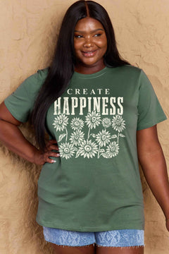 Green Tshirt with round neck and short sleeves, the caption in capital letters says CREATE HAPPINESS, with create being in small letters centered over Happiness. underneath the letters, in white as well, ten flowers arranged in three rows.