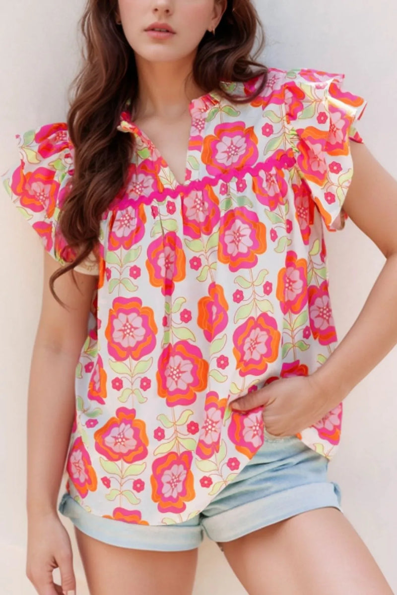 Polyester casual blouse with retro feel floral design, slightly ruffled short sleeves and  V neck.