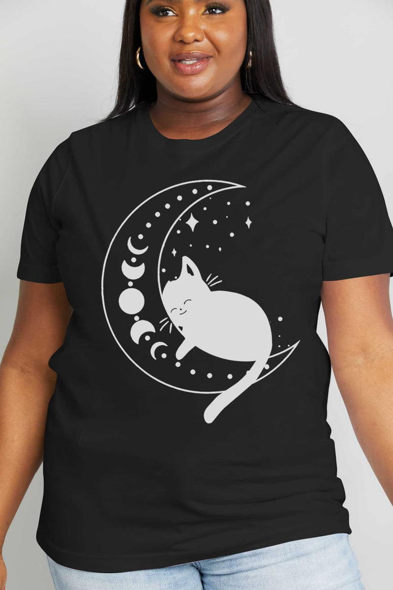 A black t-shirt with a white cat Sleeping on a half moon with stars behind and tail hanging down