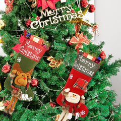 Two Christmas stockings with festive designs hanging on a decorated Christmas tree.