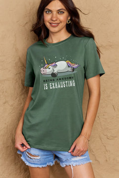 Green Tshirt with a unicorn laying on it's belly with all legs splayed out and the slogan BEING AWESOME IS EXHAUSTING under it. Round neck and short sleeves