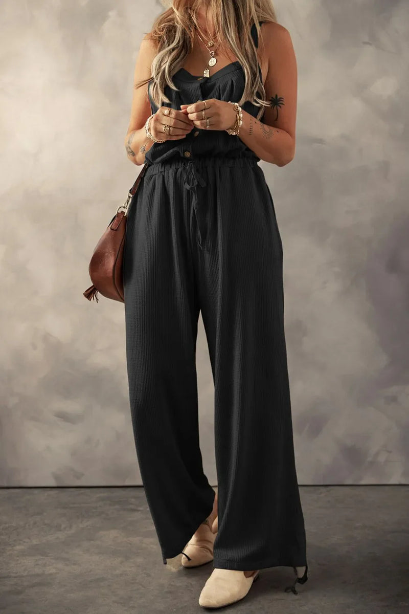 Knotted Straps Button Textured Drawstring Jumpsuit in black. wide leg pants  and four clear buttons on the top, drawstrings at the waist and bottom of each leg
