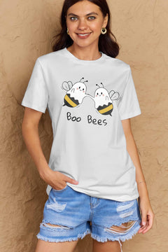 Woman wearing a white t-shirt with 'Boo Bees' graphic design against a beige background