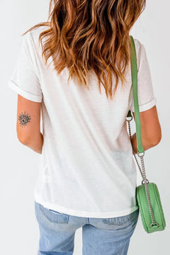 Person wearing a white t-shirt and blue jeans, carrying a green handbag on a plain background