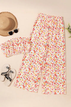 Floral outfit with strapless top and pants on a beige background