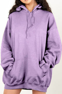 Person wearing a purple pullover hoodie on a plain background with handwarmer pocket on front.
