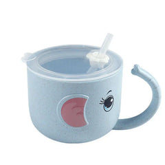 Children's blue cup with a lid and straw  with eyes and ears and handle looking like an elephant's trunk on a white background