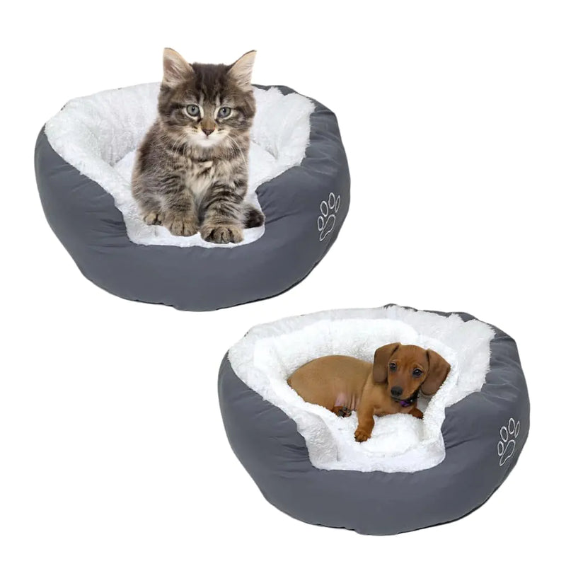 Two gray pet beds with white Sherpa padding, one containing a cat and the other a dog, on a white background.