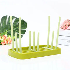 Green baby dish drying rack on a white background