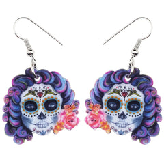 Colorful sugar skull earrings with floral details on a white background