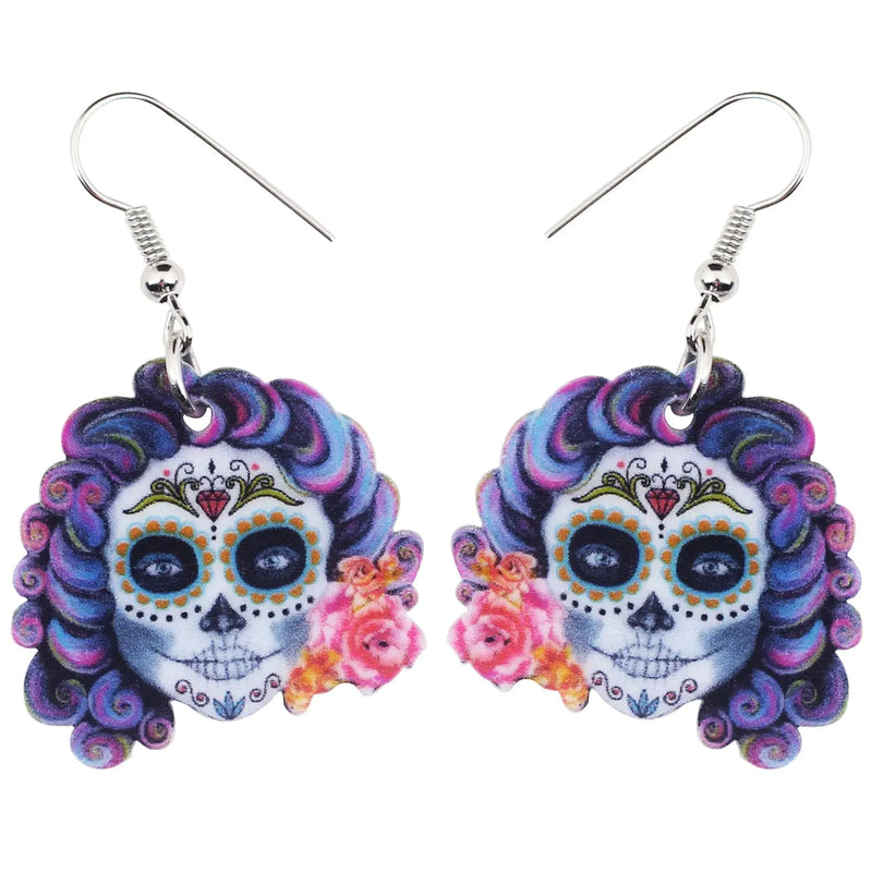 Colorful sugar skull earrings with floral details on a white background