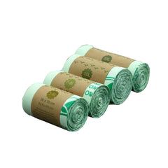 Four rolls of green biodegradable pet waste bags with brown labels on a white background