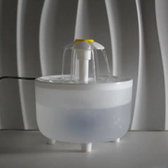 Cat water fountain with water flowing, frosted bowl with white fountain head shaped like a daisy. 