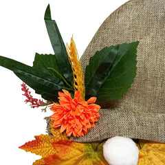 Decorative hat with orange flower, green leaves, and autumn leaves on a white background