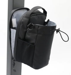Black bag attached to a pole on a white background