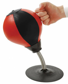 Hand punching a red and black speed bag on a white background