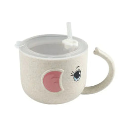 Children's tan cup with a lid and straw  with eyes and ears and handle looking like an elephant's trunk on a white background