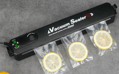 Vacuum sealer with sliced lemons on a gray surface