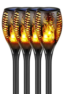 Four solar-powered outdoor lights with flame design on a white background