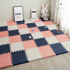 Children's play mat with pink, blue, and white squares in a room setting.